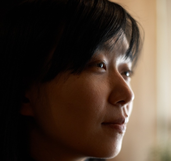 Close-up profile headshot of Han Kang.