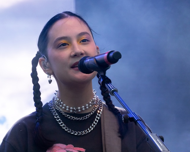 Singer Michelle Zauner sings into a microphone.